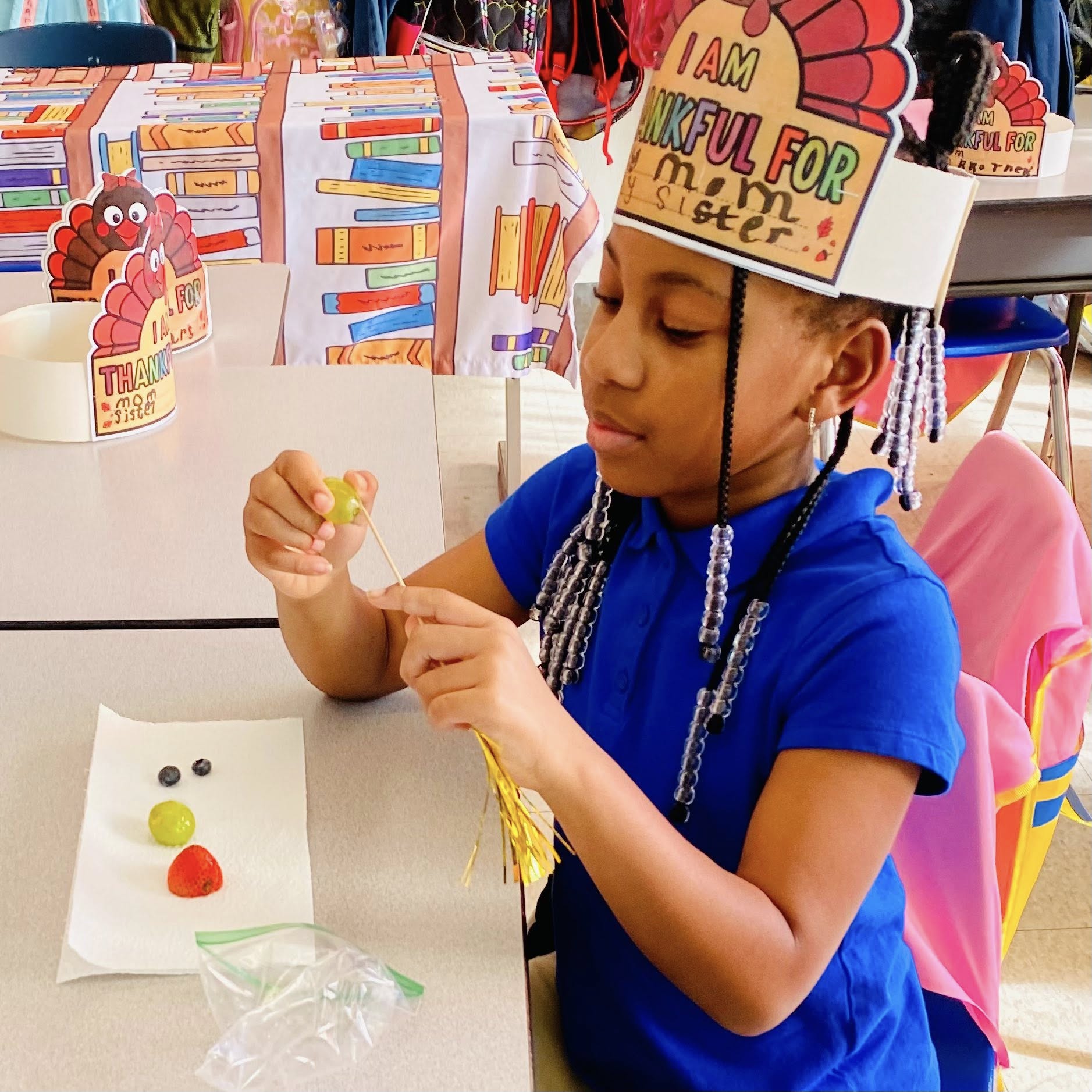 A child making a fruit kabob.